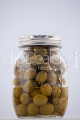 Green olive in glass jar with lid