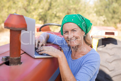 Portrait of happy woman using laptop