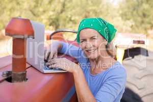 Portrait of happy woman using laptop