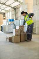 Female worker suffering from back while working in store house