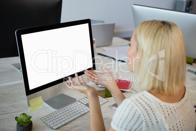 Woman gesturing while working at office