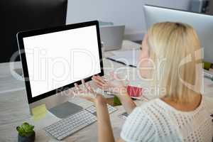 Woman gesturing while working at office