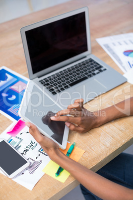 Female executive using digital tablet at desk