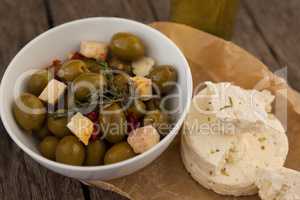 High angle view of olives with cheese on wax paper