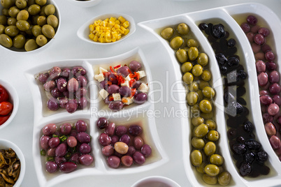 Various pickled olives on white background