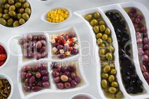 Various pickled olives on white background