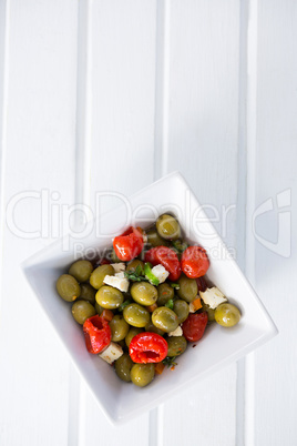 Marinated olives with herbs and spice in bowl