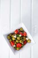 Marinated olives with herbs and spice in bowl