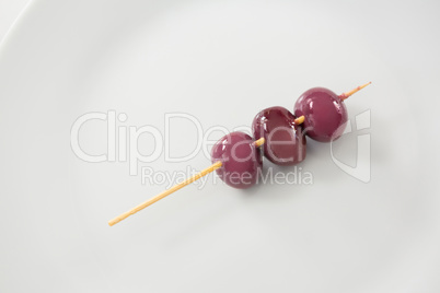 Three marinated olives in chopstick