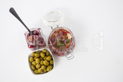 Pickled olives in jar and bowl