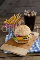 Hamburger, french fries and cold drink on table