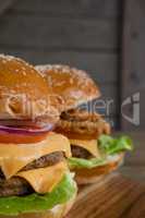 Hamburgers on chopping board