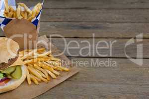 Close-up of hamburger and french fries in take way bag