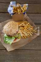 Overhead of hamburger and french fries in take way bag