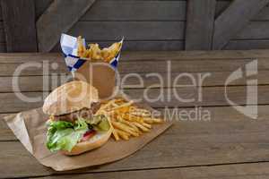 Close-up of hamburger and french fries in take way bag