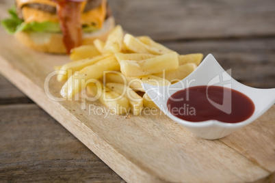 Close up of tomato sauce in bowl by french fries