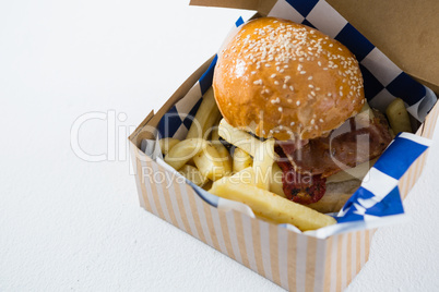 High angle view of burger and French fries in box