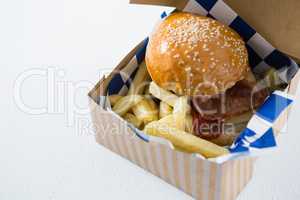 High angle view of burger and French fries in box