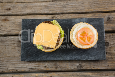 Overhead view of burger ingredients on slate