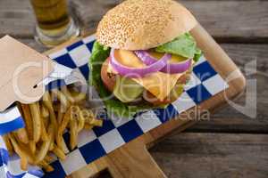 High angle view cheeseburger served with french fries and beer