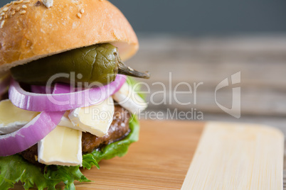 Close up of burger with cottage cheese and jalapeno pepper