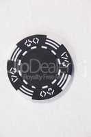 Black casino chip on white background