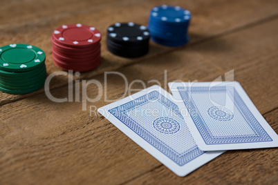 Close-up of cards and chips on wooden table