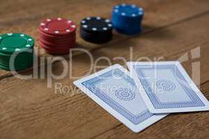 Close-up of cards and chips on wooden table