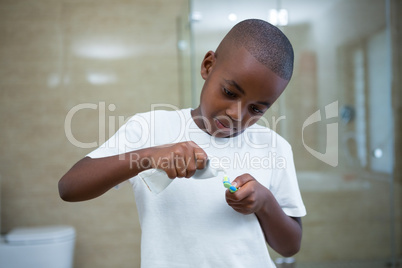 Boy removing toothpaste on brush