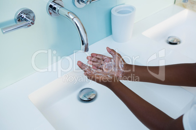High angle view of boy washing hands in sink