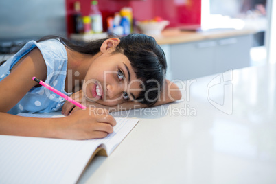 High angle portrait of girl doing homework
