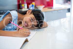 High angle portrait of girl doing homework