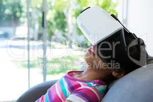 Close up of girl wearing virtual reality simulator at home