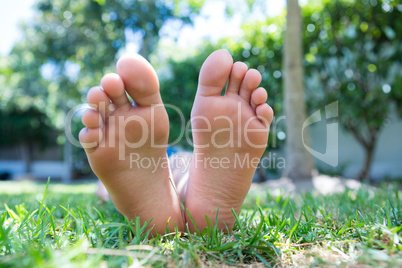 Low section of girl relaxing in yard
