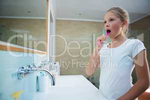 Girl brushing teeth in bathroom