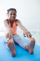 Portrait of girl touching toes while exercising