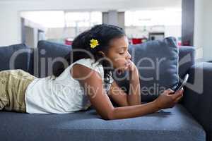 Side view of girl using phone