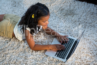 High angle view of girl using laptop