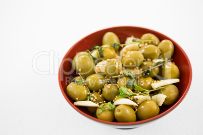 Marinated olives with garlic and herbs in bowl