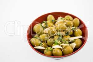 Marinated olives with garlic and herbs in bowl