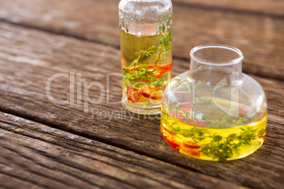 Olive oil with rosemary and red chili pepper in container