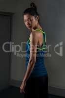 Determined woman standing in fitness studio