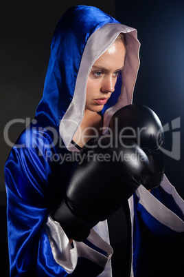 Determined woman wearing boxing gloves