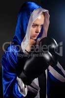 Determined woman wearing boxing gloves