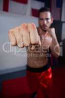 Man practicing boxing in fitness studio