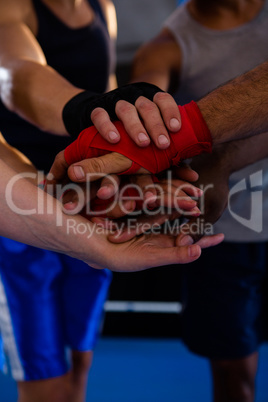 Close-up of boxers stacking hands