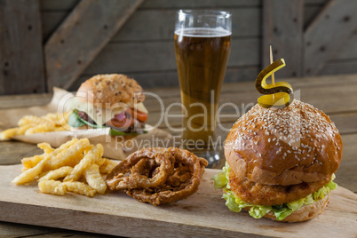 Hamburger, french fries and onion ring with glass of beer