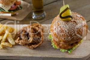 Hamburger, french fries and onion ring with glass of beer