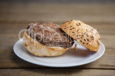 Hamburger in plate on wooden table