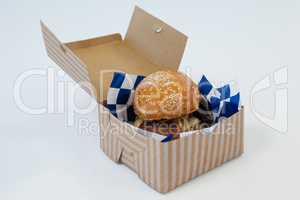 Hamburger in take away container on white background